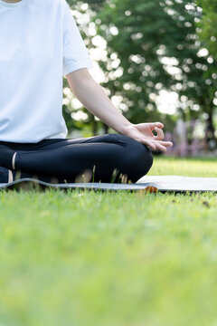 woman practicing meditate on the park. Asian woman doing exercises in morning. balance, recreation, relaxation, calm, good health, happy, relax, healthy lifestyle, reduce stress, peaceful, Attitude.