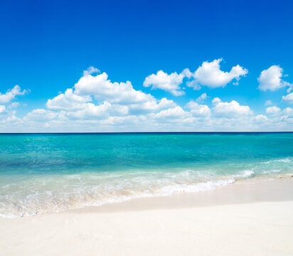 Beach and beautiful tropical sea. Blue sky and white clouds.