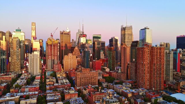 Sunrise cityscape with Manhattan skyscrapers, New York. Elevated angle of urban architecture, warm morning light, dense towers and residential block.