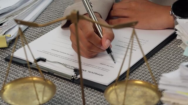Signing Legal Agreement with Scales of Justice in Law Office
