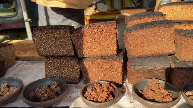 Traditional Latvian rye bread displayed at a farmers market, local food, artisan baking, regional cuisine, handmade produce, food culture, sustainable shopping.