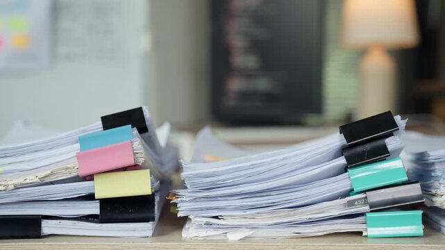 Large Stacks of Business Documents and Paperwork in Busy Office