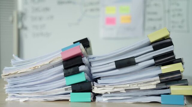 Large Stacks of Paper Documents and Office Files on Desk