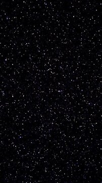 Softly Flickering Light Points on a Dark Surface. Dense white and blue specks gently brighten and fade across a black textured background.
