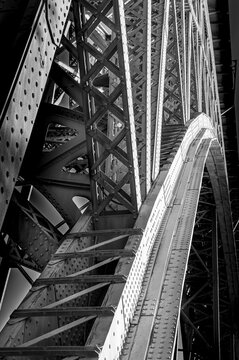 Black and White Steel Arch Construction with Intricate Ironwork, Rivets, and Lattice Girders