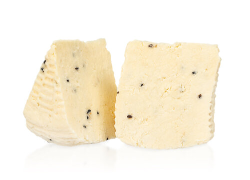 Fresh white cheese blocks with black pepper flecks displayed on a white background, showcasing texture and creamy consistency ideal for culinary use