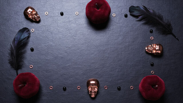 Gothic Halloween Flat Lay Background with Skulls, Velvet Apples, and Feathers