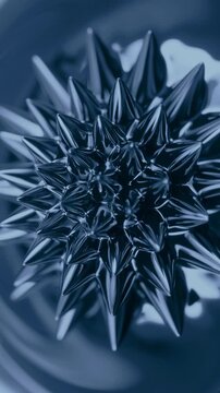 Ferrofluid Spikes Shifting Under a Magnetic Field. Glossy black liquid forms moving conical peaks as a magnet changes position.