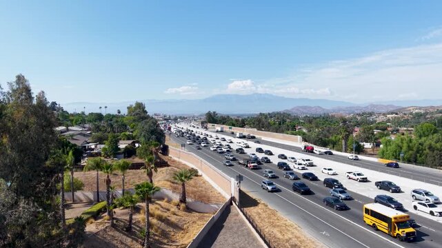 Low Altitude Aerial Shot of Interstate 15 Southbound Traffic Through Corona California on a Friday Afternoon. Heavily Congested Freeway for Commuters from Orange County To Riverside County.