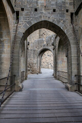 Fototapeta premium Medieval Stone Castle Archway Entrance With Wooden Drawbridge and Historic Gateway