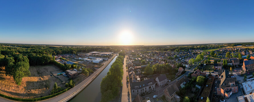 Aerial Panoramic View of Rijkevorsel, Belgium at Golden Hour with Canal and Residential Neighborhoods