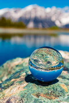 Crystal ball alpine summer landscape shot with reflections and Mount Wilder Kaiser in the background at Mount Hartkaiser, Ellmau, Kufstein, Tyrol, Austria