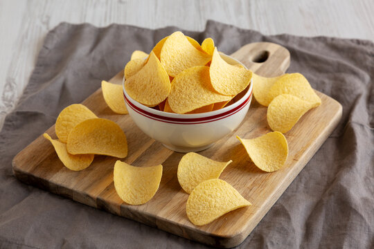 Crispy Cheese and Onion Flavoured Potato Chips in a Bowl, side view.