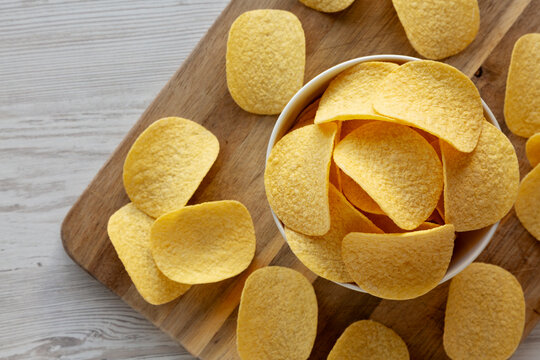 Crispy Cheese and Onion Flavoured Potato Chips in a Bowl, top view. Copy space.