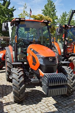 Orange Zetor tractor parked at outdoor agriculture fair