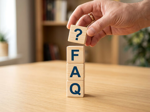 Person stacking wooden blocks with faq