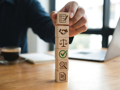 Person stacking wooden blocks on a desk