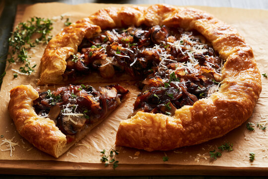 Open pie with mushrooms, caramelized onions, and Parmesan