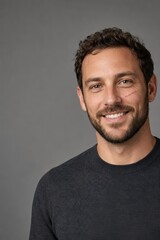 Obraz premium Man with a facial scar smiling in a bright studio portrait
