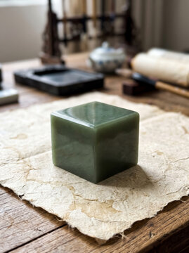 Green jade seal stamp block on calligraphy paper