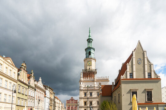 View of the historic Poznan Town Hall with its distinctive tower rising above the colorful merchant houses in the Old Market Square of Poznan, Greater Poland Voivod, Poland.