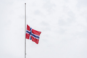 Norway flag flying at half mast honoring national mourning © photoopus