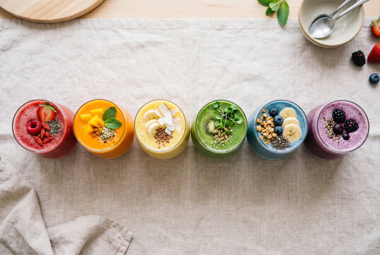 Colorful Fruit Smoothies with Healthy Toppings on Table
