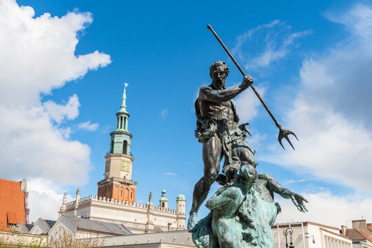 View of the Proserpina fountain statue in front of the historic Poznan Town Hall under a bright blue sky in Poznan, Greater Poland Voivod, Poland.