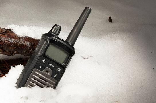 Copy space next to a black walkie talkie in the snow