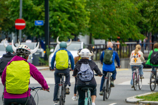 Cyclists wearing Viking helmets riding bicycles in Oslo