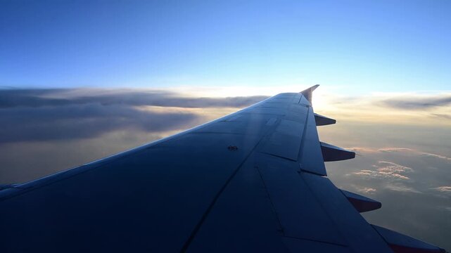 Beautiful window view while traveling by an airplane during sunset.
