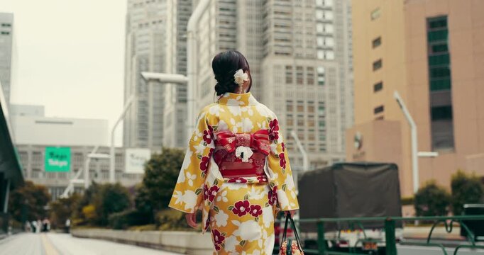 Travel, woman and walking in kimono in city for adventure, exploring and journey in Japan street. Back, person and commute in traditional yukata for weekend trip, sightseeing and holiday vacation