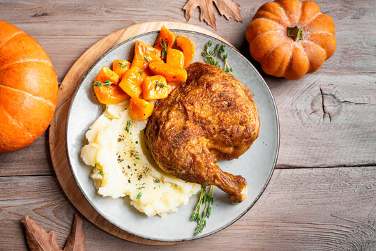 Autumn meal: chicken quarter with glazed pumpkin and mashed potato