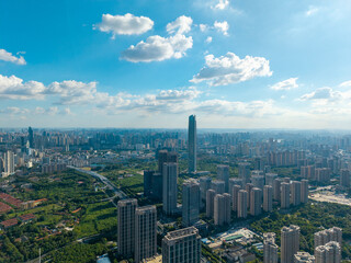 Fototapeta premium A high angle aerial view shows the modern urban skyline and tall skyscrapers of the city of Wuhan in China during a sunny day