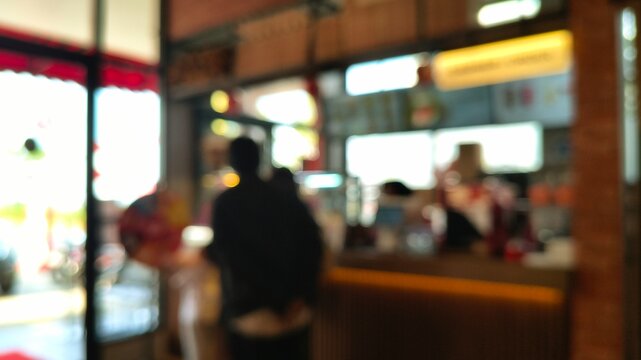 Blurred Bokeh Interior of Modern Cafe Restaurant Counter with Customer Silhouette Background