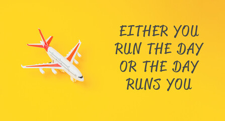 A toy airplane placed on a vibrant yellow background next to a motivational quote, suggesting themes of travel and personal empowerment. © Алла Морозова