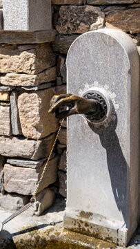 Old stone fountain with bronze animal water spout