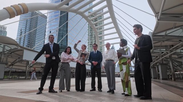 A varied team of business professionals working together outside in a contemporary city environment