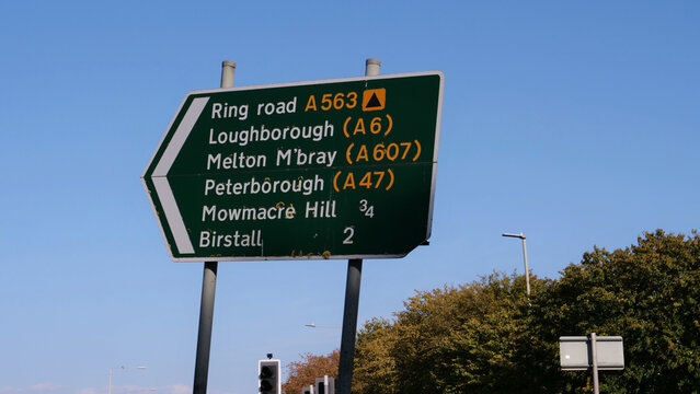 British green primary route directional road sign pointing to Ring Road A563 Loughborough A6 and Peterborough A47