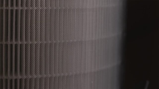 Macro shot of hands putting clean HEPA filter in air cleaner