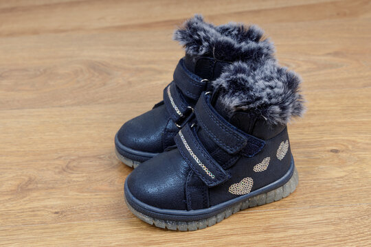 Blue Girl Winter Boots with Sparkly Straps on Wooden Floor, Cozy Kids Footwear. Winter shoes for Kids