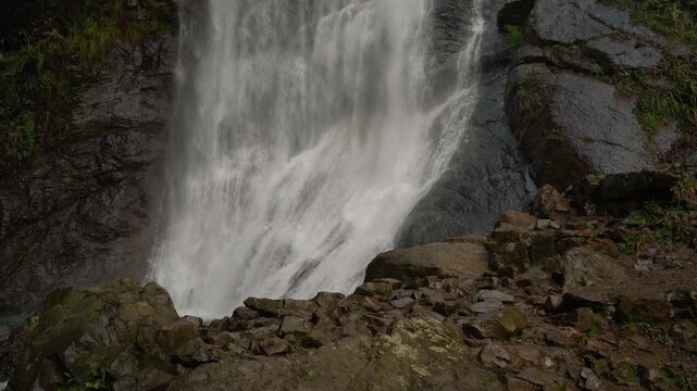 Close-up of a powerful waterfall cascading down dark cliffs.