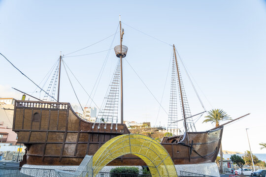 View of the Barco de la Virgen ship replica with tall masts and rigging, situated near the waterfront in Santa Cruz de La Palma, Canary Islands, Spain.