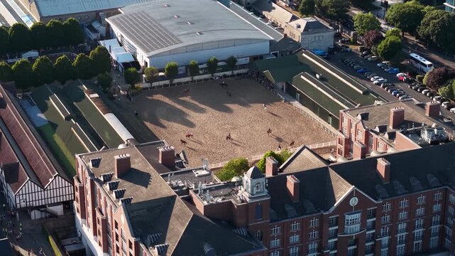 Aerial view of horses riding in ring at RDS Grounds with Dublin buildings, Ireland