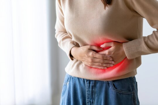 Stomach pain. Young woman touches her abdomen to acute pelvis pain. Glowing red light sign painful cramp, menstrual cycle distress ache or digestive spasm. Bladder infection symptom. Belly discomfort