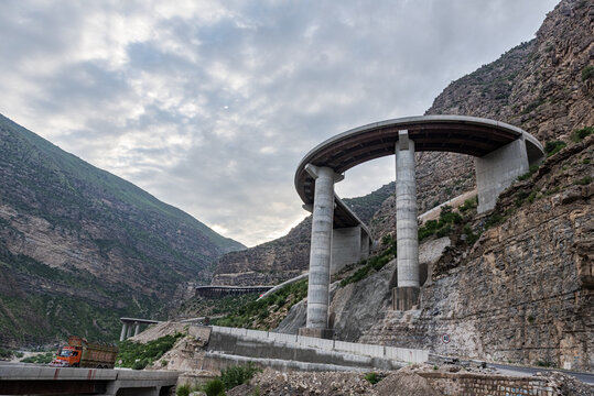View of the curved concrete viaduct of Fort Munro Road winding through the rocky mountains of the Sulaiman Range in Fort Monroe, Punjab, Pakistan.