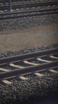 Empty railway tracks stretching into the distance on a cloudy day