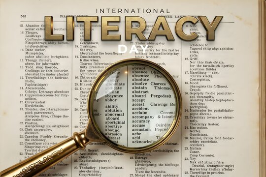 International Literacy Day concept with magnifying glass over old dictionary book page