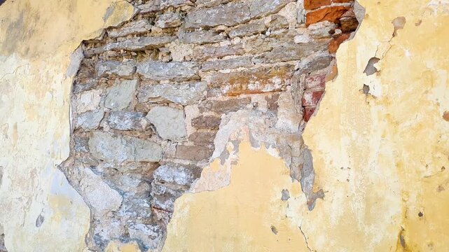 A damaged plastered wall. A hole in the plaster; restoration and repair of walls and buildings. Plaster that has fallen off the wall.