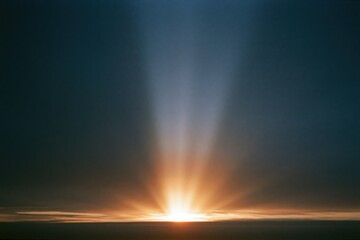 Fototapeta premium The Sunrise over the Horizon with Radiant Beams Piercing the Sky